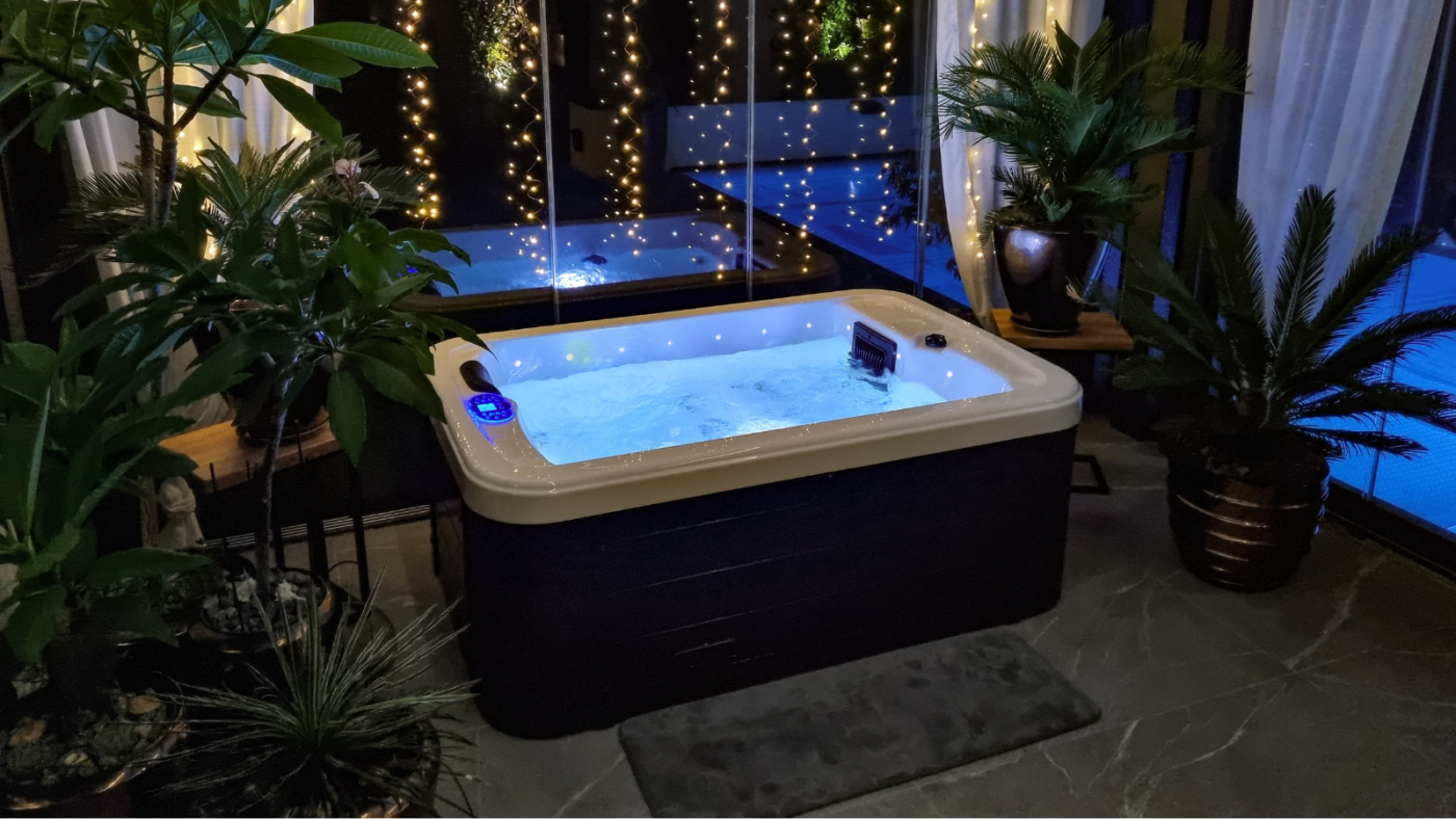Illuminated indoor jacuzzi at night.